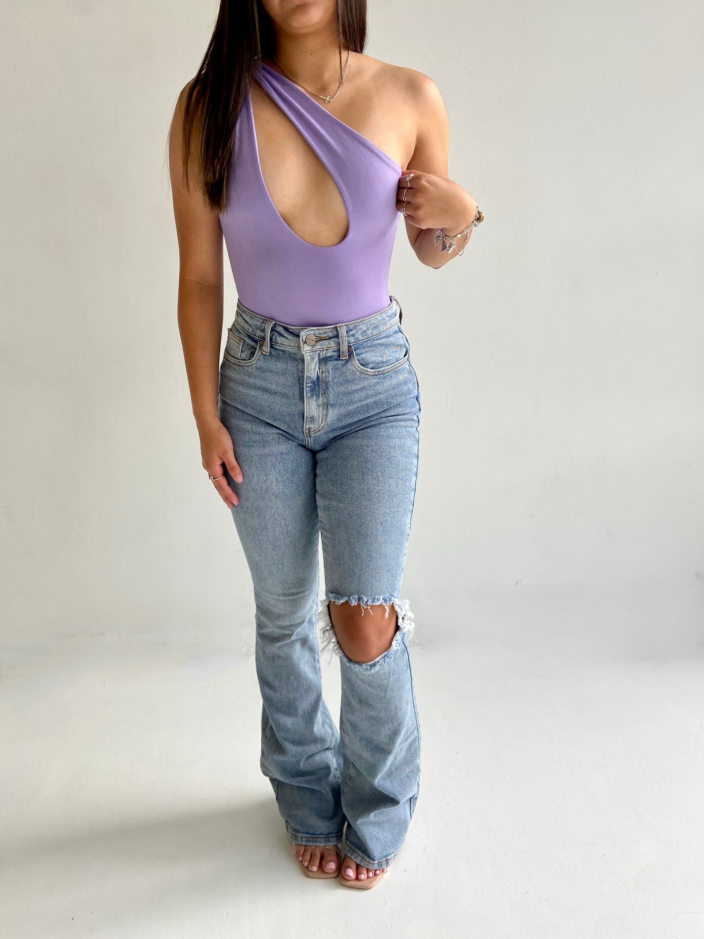 Asymmetrical purple body suit